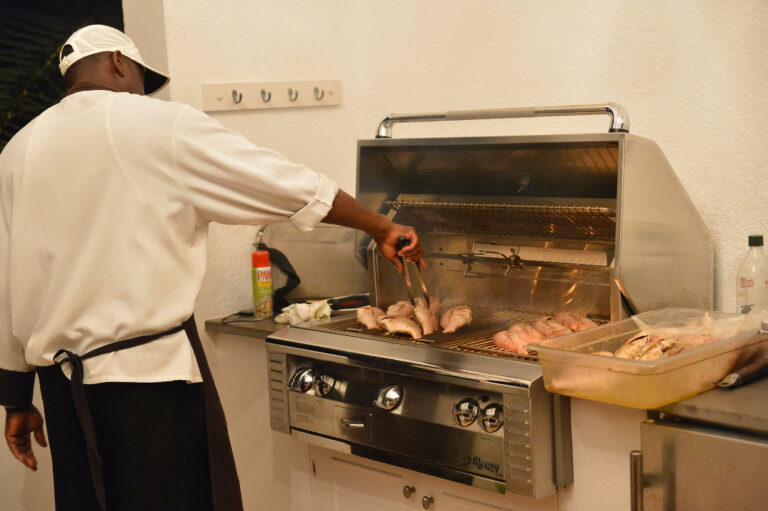 Chef grilling fish at Villa Alegria Anguilla
